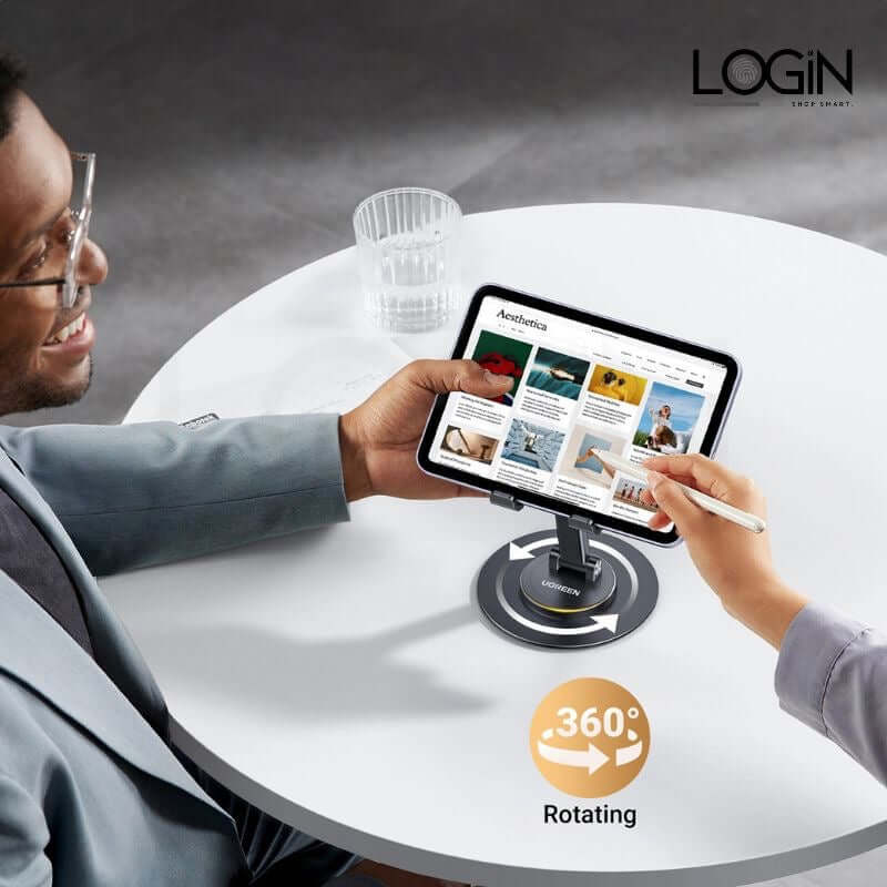 Man using a 360° rotating folding phone holder while viewing content on a tablet, enhancing hands-free operation.